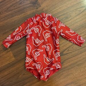 Pre-loved red Shaka Of One Sea rash guard suit!